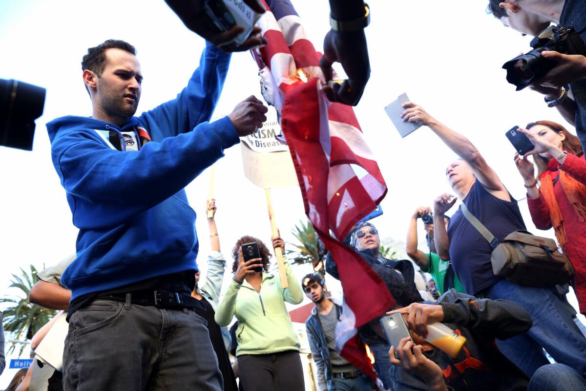 A protester burns an American flag during a rally against police violence in Los Angeles in 2014.