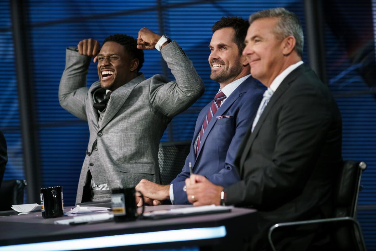 From left, Reggie Bush, Matt Leinart and Urban Meyer jokes around football during the taping of BIG NOON KICKOFF at FOX studios in Los Angeles.