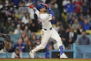Los Angeles Dodgers' Andy Pages singles during the eleventh inning of a baseball game.