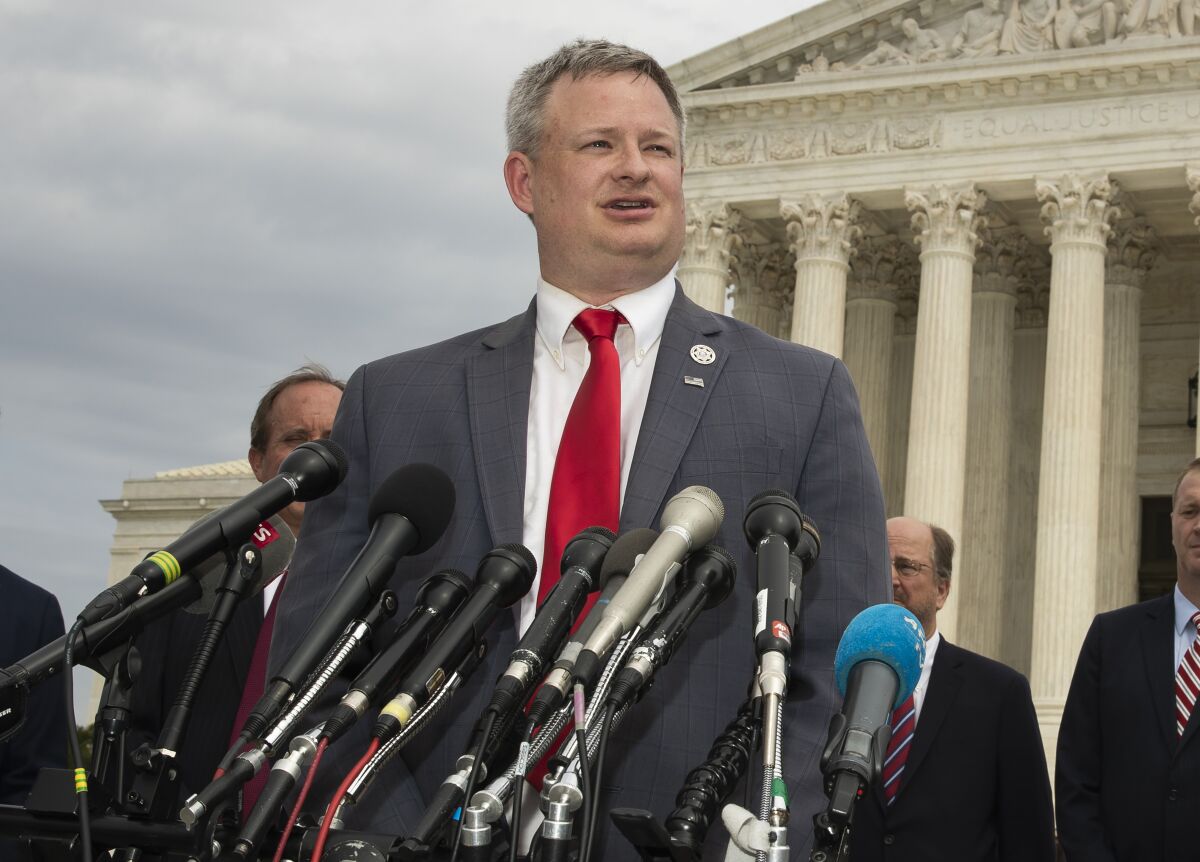 FILE- In this Sept. 9, 2019, file photo, South Dakota Attorney General Jason Ravnsborg, joined by a bipartisan group of state attorneys general, speaks to reporters in front of the U.S. Supreme Court in Washington. A judge overseeing the criminal trial of South Dakota Attorney General Jason Ravnsborg is ordering medical providers to turn over their health records for the pedestrian who was struck and killed by Ravnsborg last year. The order comes after Ravnsborg’s defense alleged in court documents that Boever’s Sept. 12 death may have been a suicide. (AP Photo/Manuel Balce Ceneta)