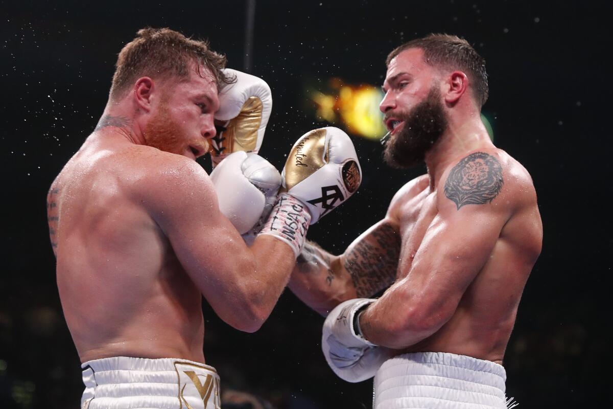 Canelo ?lvarez, left, and Caleb Plant exchange punches during their fight Saturday.