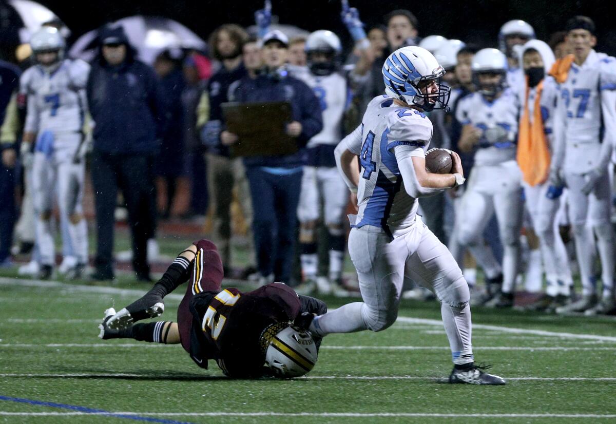 Crescenta Valley RB Sebastian DeLeon breaks a tackle in the second half of the CIF SS Div. X championship game vs. Simi Valley High, at SMHS in Simi Valley on Saturday, Nov. 29, 2019.