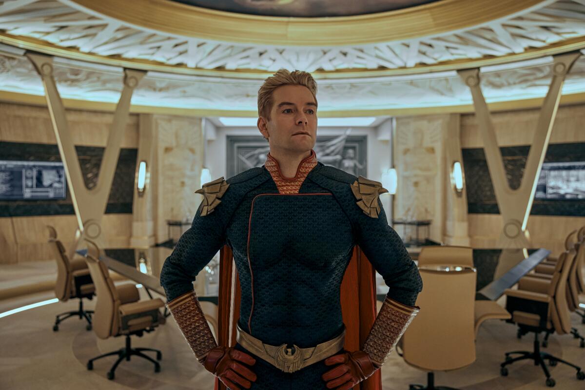 A terrifyingly powerful and unstable superhero, Homelander, stands with hands on hips in Prime Video's "The Boys."
