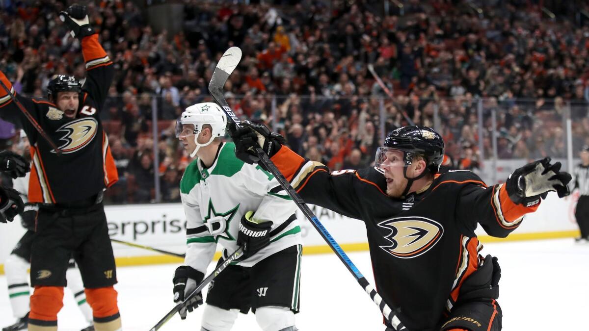 Ryan Getzlaf (left) reacts to a goal by Ondrej Kase (right) of the Ducks against the Dallas Stars. Blake Comeau (center) of the Dallas Stars looks on during the third period.
