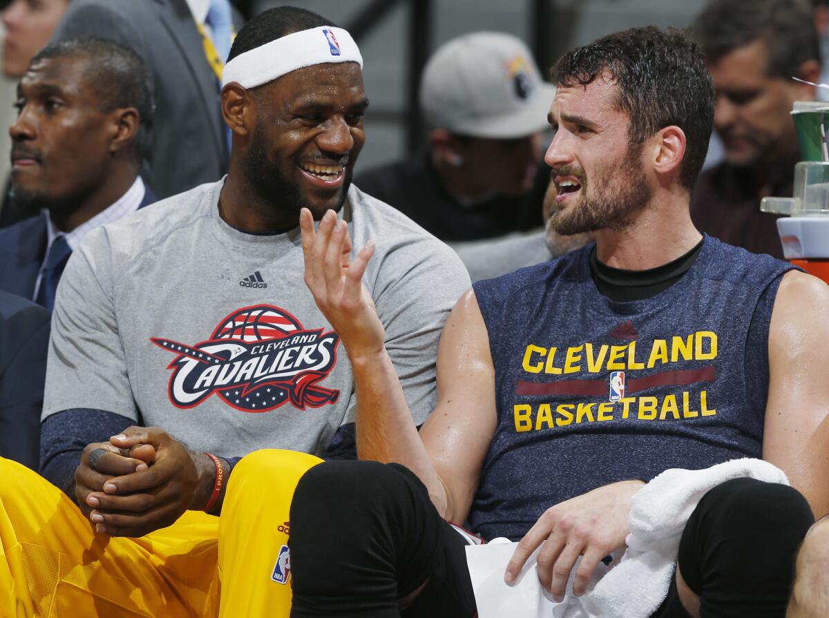 Cleveland Cavaliers forwards LeBron James, left, and Kevin Love sit on the bench on Nov. 7, 2014.