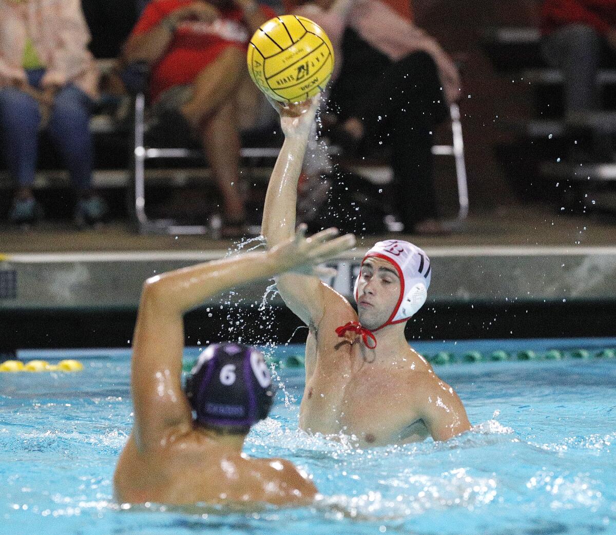 Burroughs' Chet Conlan lobs a shot that scores over the reach of Hoover's Araanm Minasyan and the Hoover goalie in the Pacific League preliminary boys' water polo tournament at Arcadia High School on Tuesday, October 29, 2019. Hoover won the game advancing to the finals.