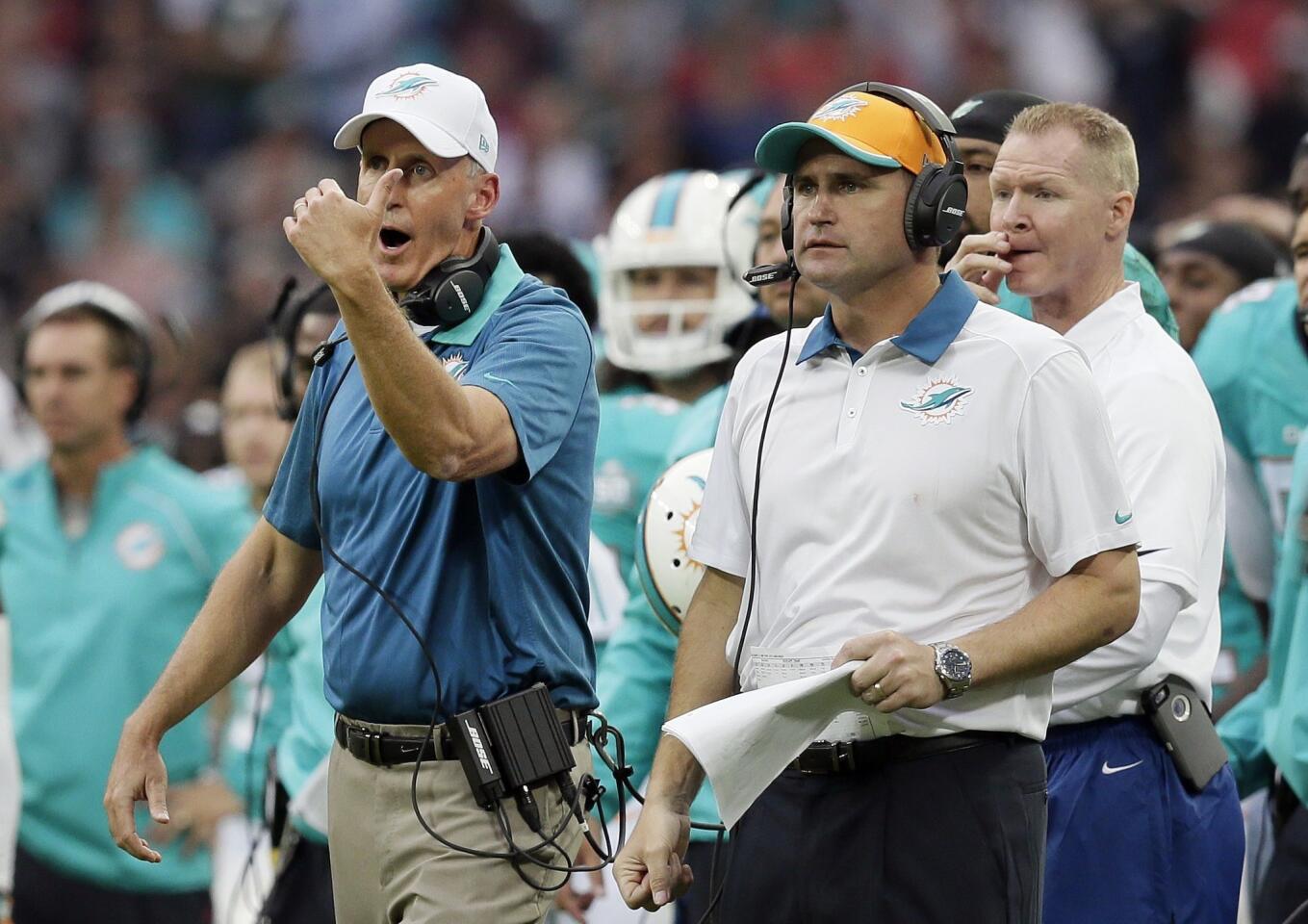 Miami Dolphins head coach Joe Philbin, left, gestures during the NFL football game between the New York Jets and the Miami Dolphins and at Wembley stadium in London, Sunday, Oct. 4, 2015. (AP Photo/Tim Ireland) ORG XMIT: NYOTK