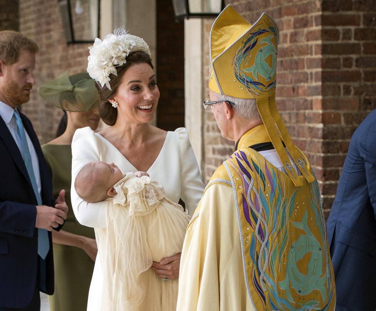 Catherine, Duchess of Cambridge, speaks to Archbishop of Canterbury Justin Welby as she arrives carrying Prince Louis for his christening service at the Chapel Royal at St. James' Palace in London on July 9, 2018.