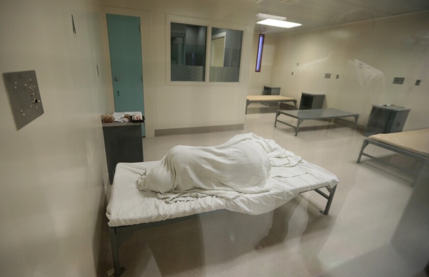 An inmate sleeps in a room on the 4th floor of the medical unit of the Twin Towers Correctional Facility. This area houses inmates with the highest level of need - both psychiatric and medical.