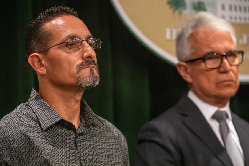 Los Angeles, CA - September 26: Los Angeles County District Attorney George Gascon, right, announces the exoneration of Mr. Gerardo Cabanillas, left, after more than 28 years in prison for crimes he did not commit. In 1996 Mr. Cabanillas was wrongfully convicted of robbery, kidnapping, and sexual assault. (Francine Orr / Los Angeles Times)