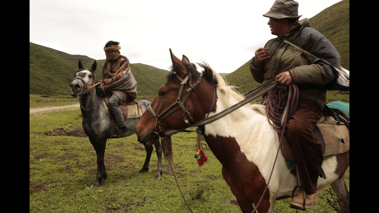 Ze Huajia, left, and Djuko ride in Meiruma village, outside Aba. Despite the Chinese government's efforts to settle nomads, many continue to pursue their traditional lifestyle.