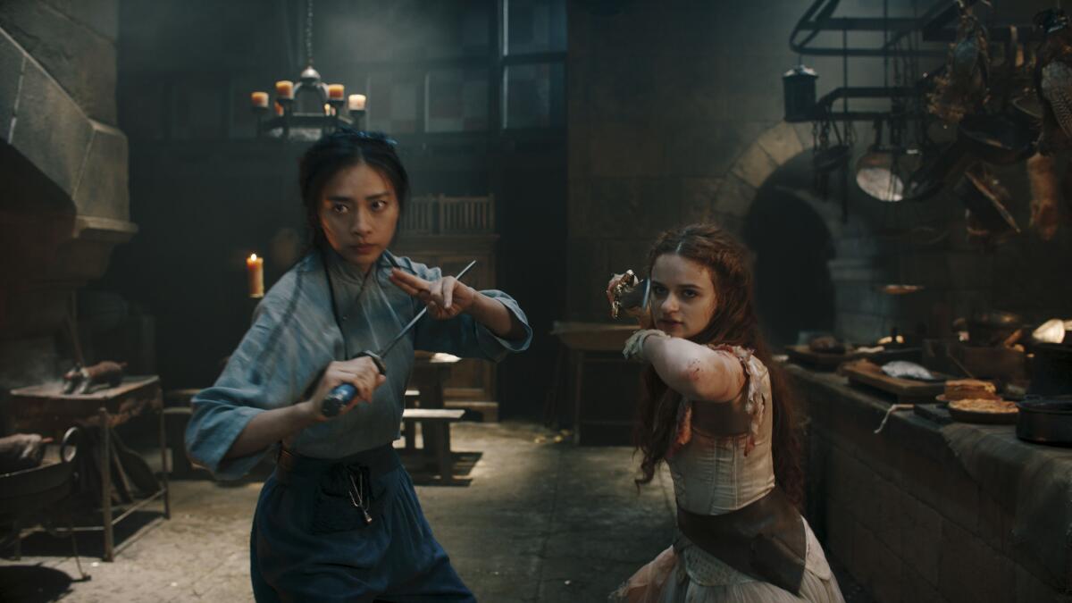 Two women wield weapons: Veronica Ngo and Joey King prepare to face their opponents in "The Princess."