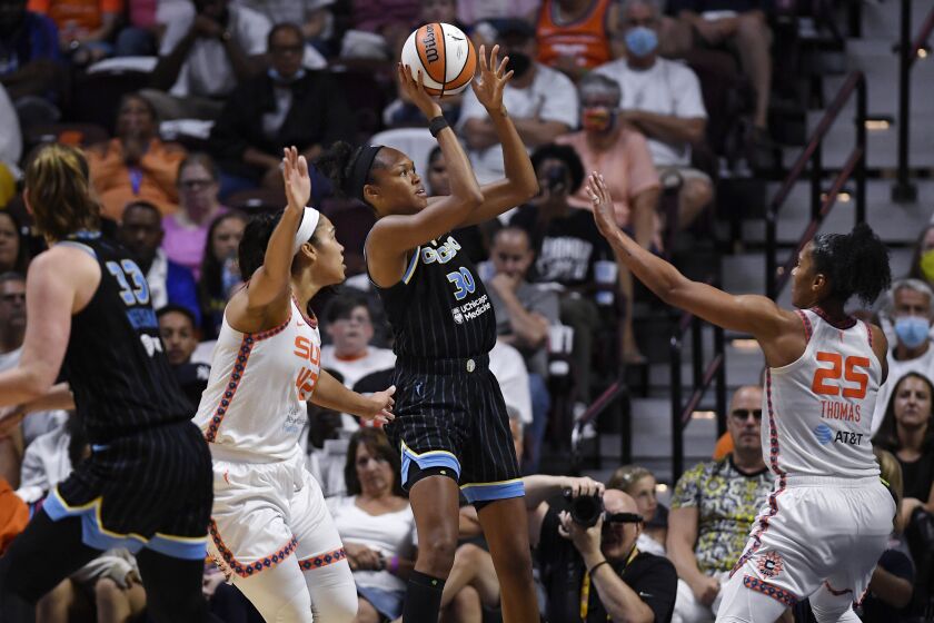 Chicago Sky forward Azura Stevens shoots between Connecticut Sun center Brionna Jones, left, and Alyssa Thomas, right, during Game 3 of a WNBA basketball semifinal playoff series, Sunday, Sept. 4, 2022, in Uncasville, Conn. (AP Photo/Jessica Hill)
