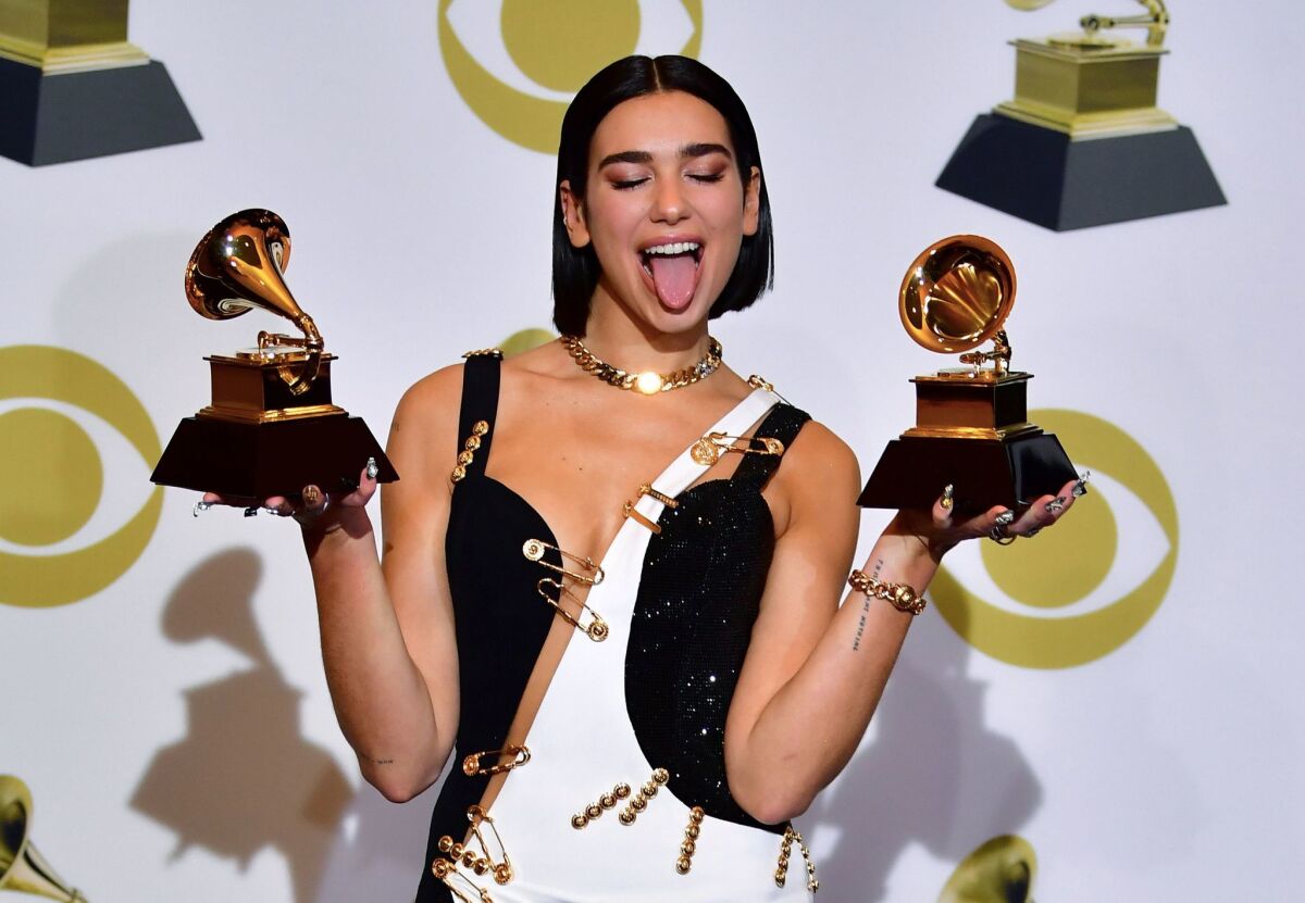 La cantante Dua Lipa posa con sus trofeos en la sala de prensa del Grammy.