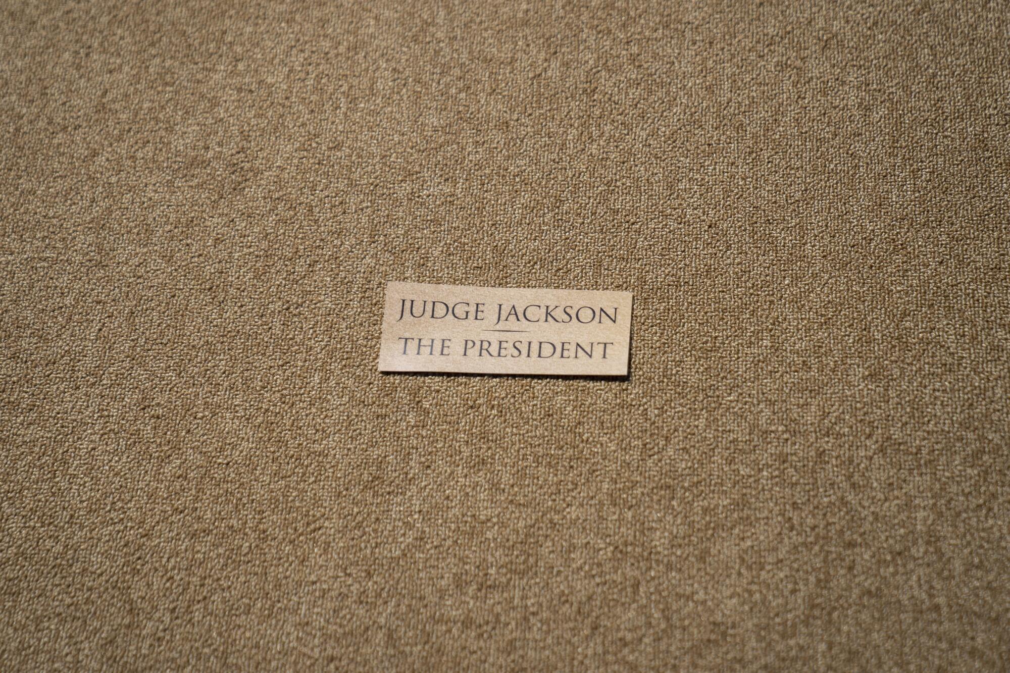 A marker indicating the standing position for Judge Ketanji Brown Jackson and President Biden on stage. 