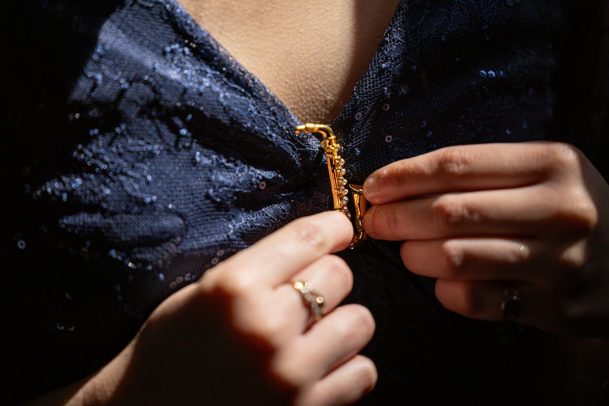 Ismerai Calcaneo clutches her saxophone pin while riding an LAUSD school bus to the Oscars