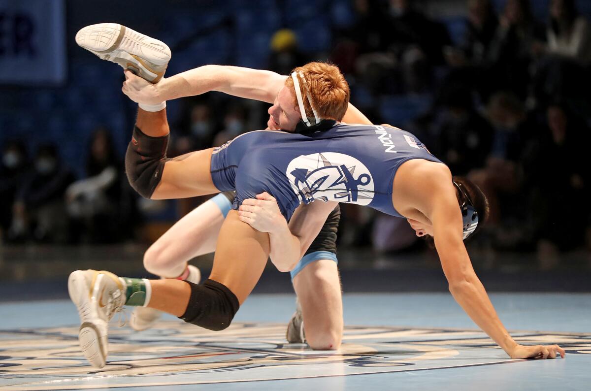 Corona del Mar's JJ Strapp tries to turn Newport Harbor's Matthew Pinon to the mat during the Battle of the Bay match.
