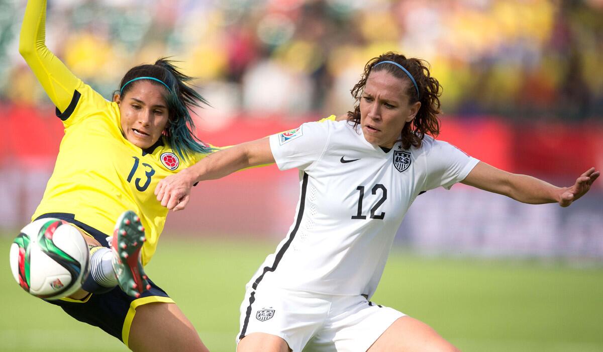 Colombia's Angela Clavijo, left, and USA's Lauren Holiday vie for the ball during their FIFA Women's World Cup match on Monday. The U.S. defeated Colombia, 2-0, to advance to the quarterfinals.