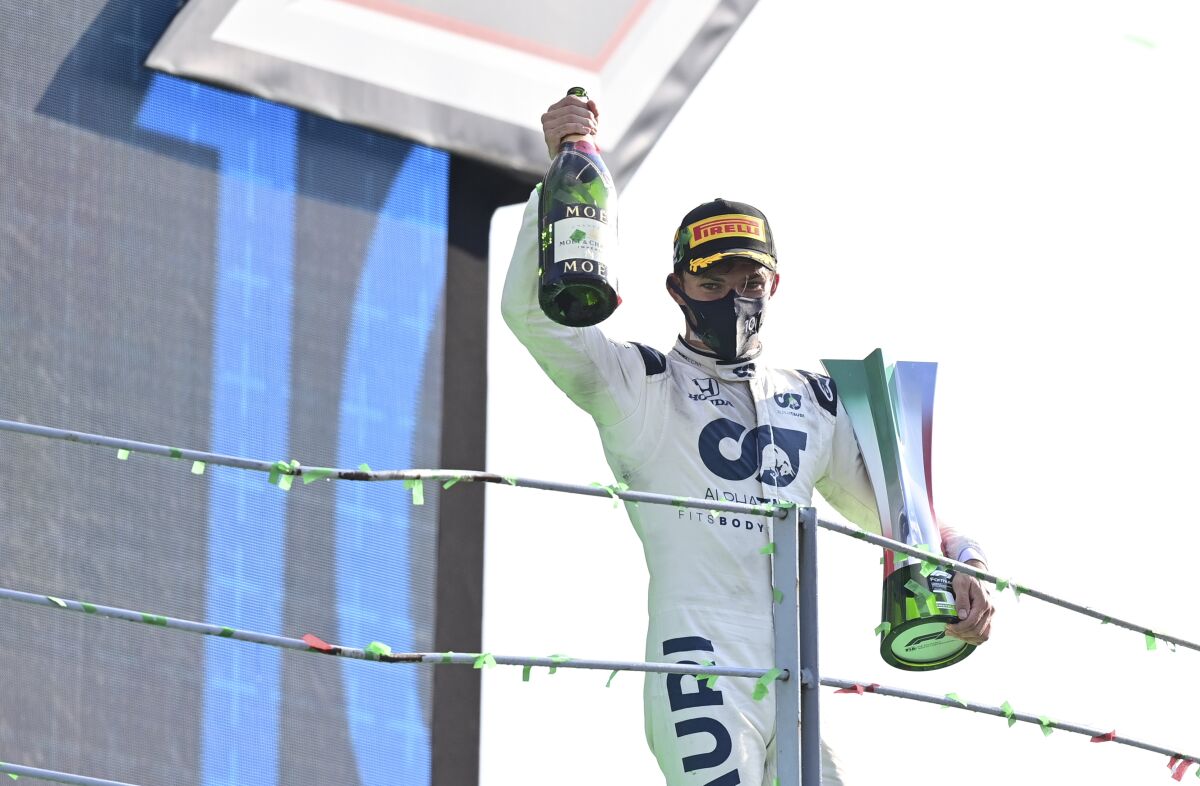 Pierre Gasly celebrates on the podium after winning the Formula One Grand Prix.
