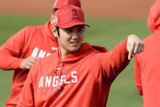 Los Angeles Angels' Shohei Ohtani gestures during a spring training baseball workout.