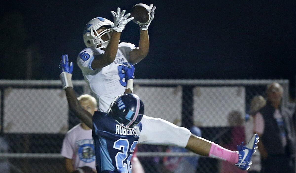 Corona del Mar's Taeveon Le pulls in a touchdown pass on Oct. 23.