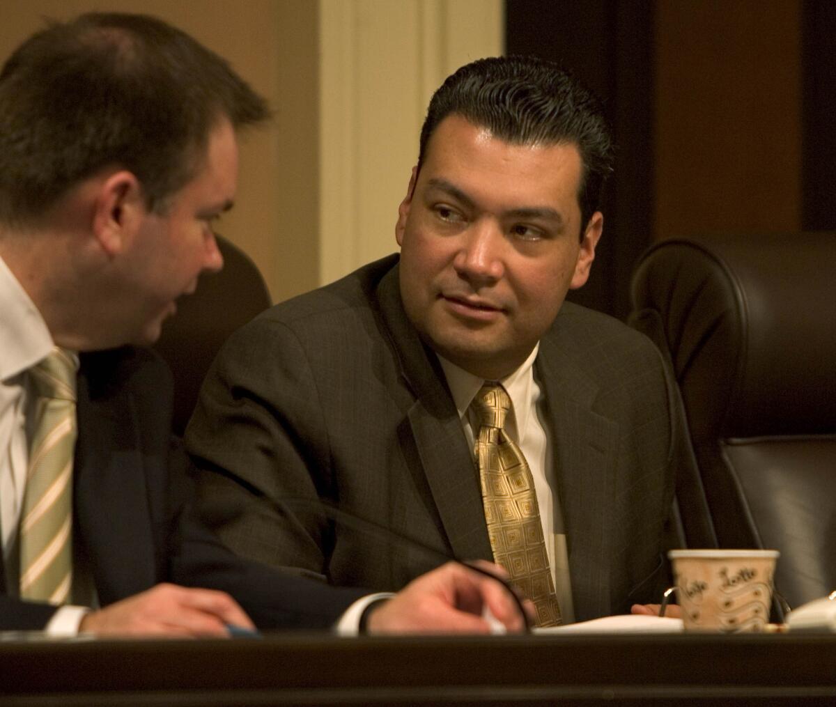 State Senator Alex Padilla (D¿Pacoima), center, listens to a staffer during a Rules Committee hearing in the state Capitol.