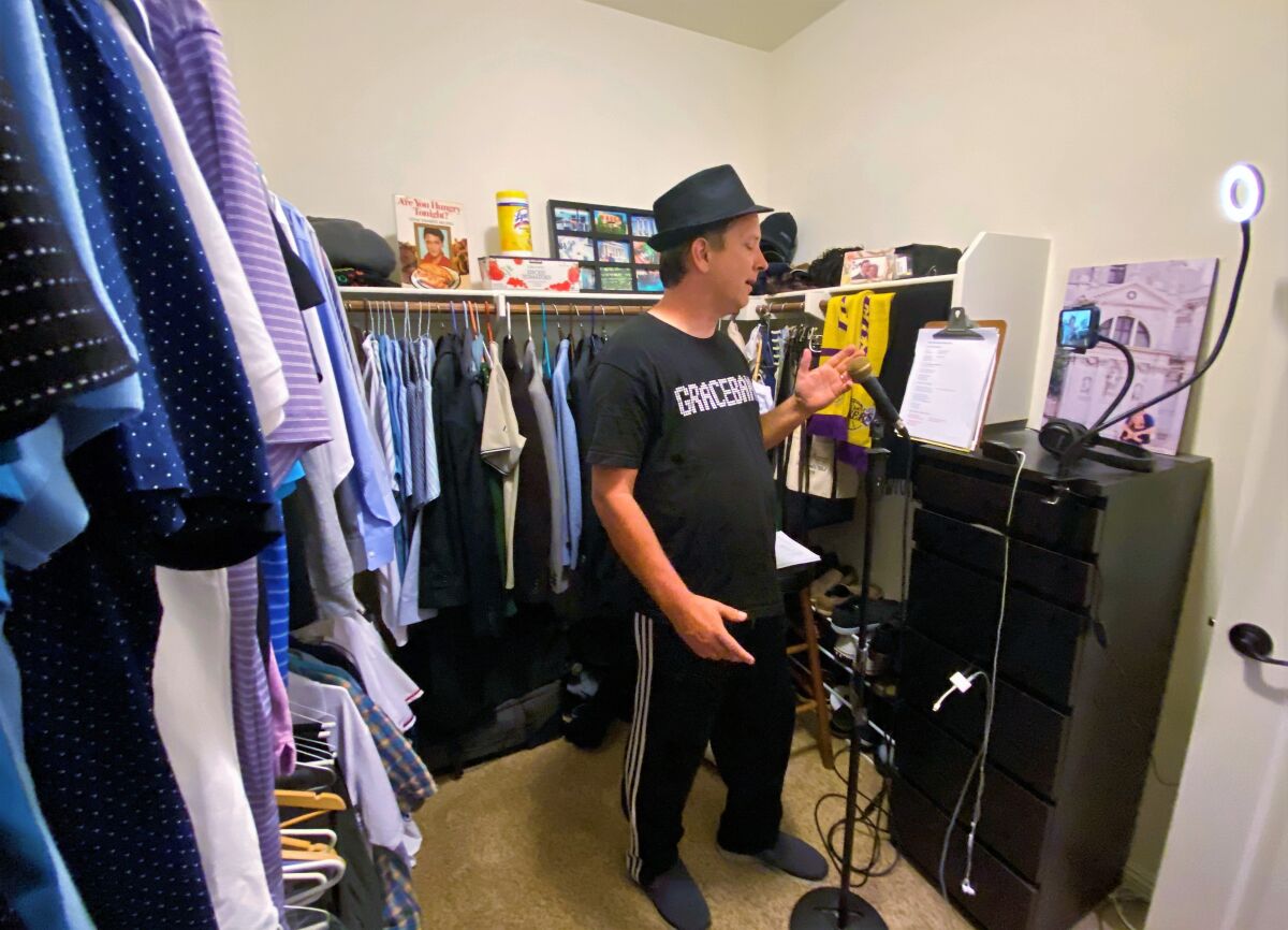 Chris Maddox, 47, records a parody song video in the closet of his Carlsbad home. The longtime Elvis Presley tribute artist is now writing parody songs about living in quarantine due to the COVID-19 pandemic.