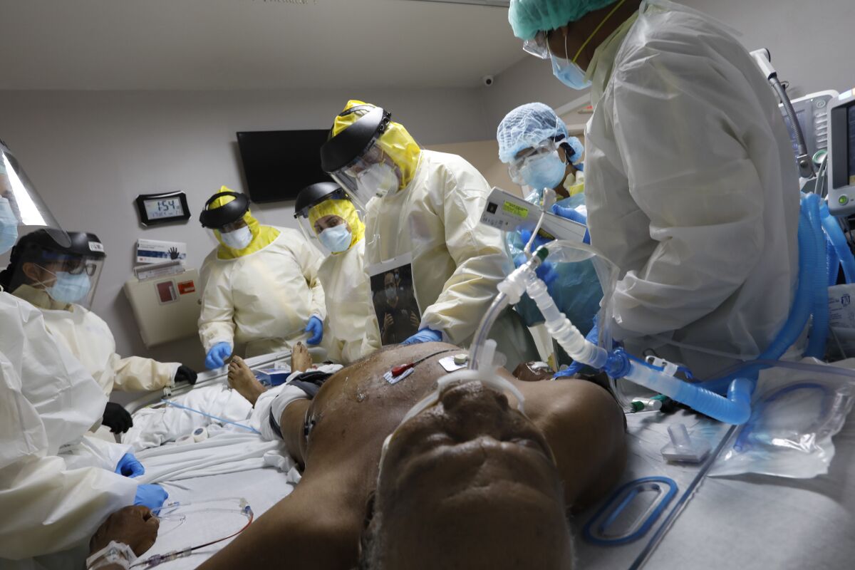 Medical personnel perform emergency treatment on a coronavirus patient in Houston after putting him on a ventilator.