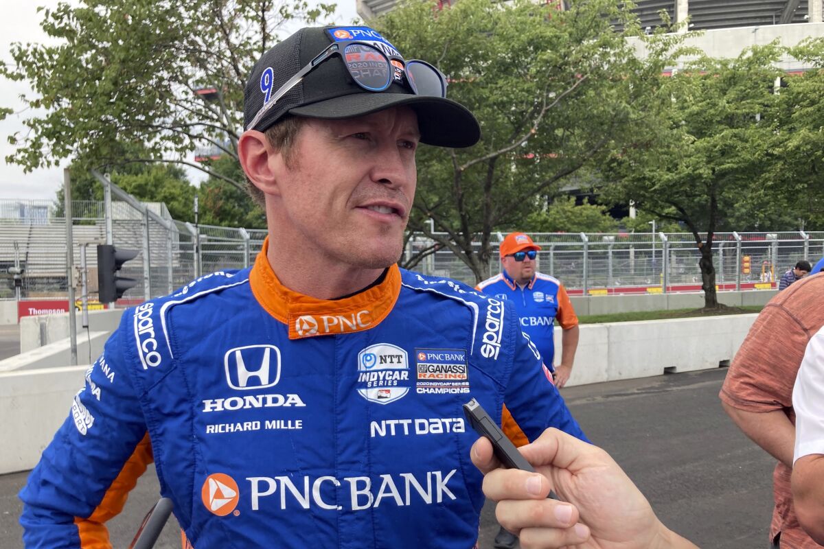 Six- time IndyCar champion Scott Dixon chats with the media before the start of practice of the IndyCar auto race, Friday, Aug. 6, 2021, in Nashville, Tenn. (AP Photo/Dan Gelston)