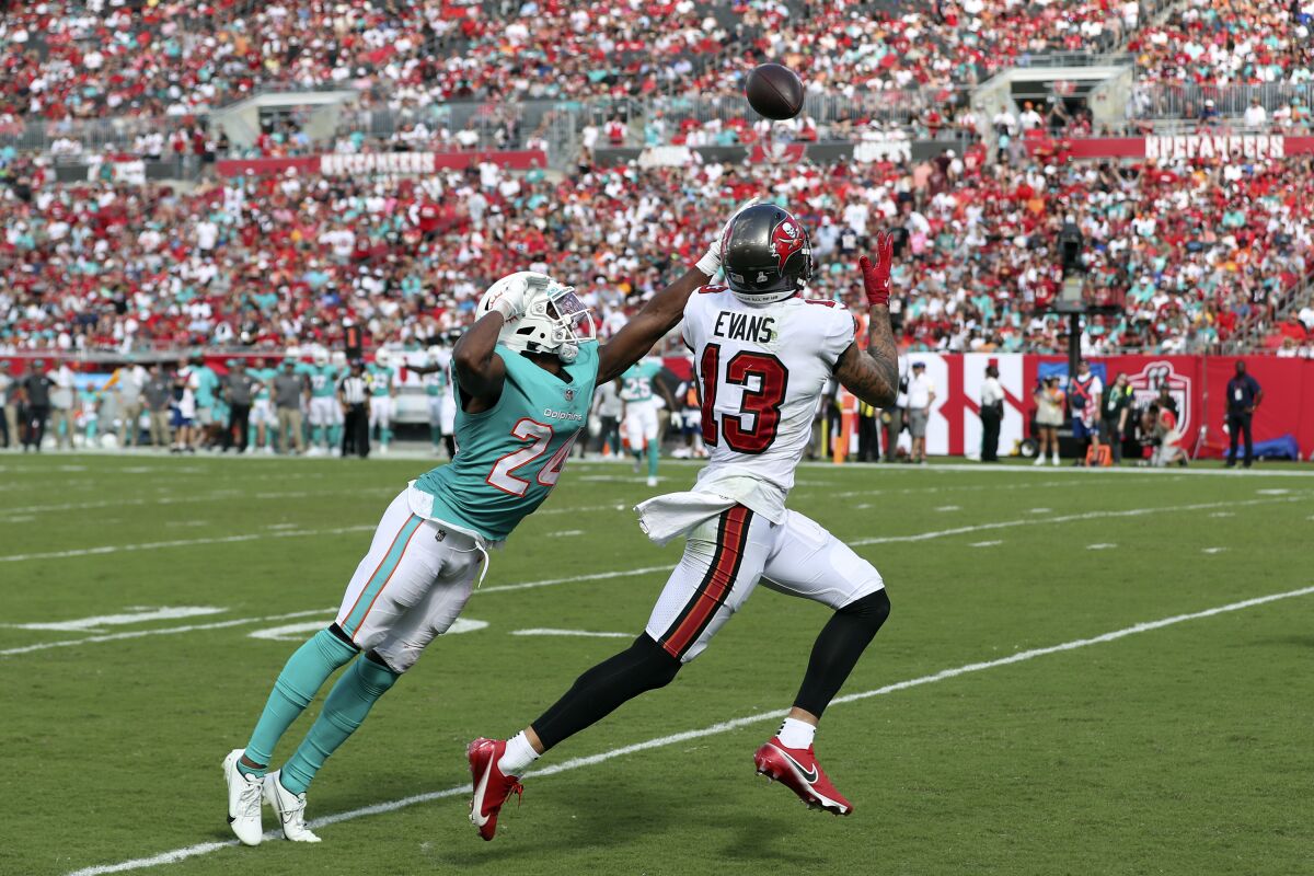 Tampa Bay Buccaneers wide receiver Mike Evans (13) beats Miami Dolphins cornerback Byron Jones (24) on a 34-yard touchdown pass from quarterback Tom Brady during the second half of an NFL football game Sunday, Oct. 10, 2021, in Tampa, Fla. (AP Photo/Mark LoMoglio)
