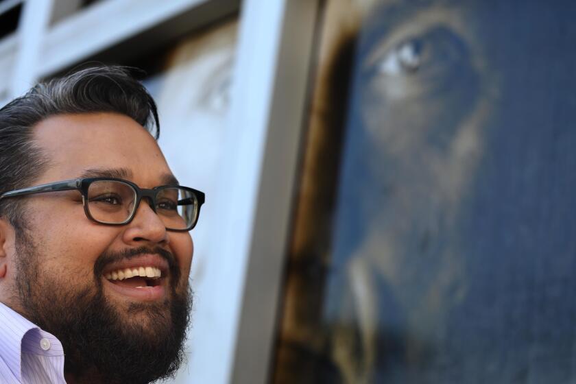 LOS ANGELES, CA - OCTOBER 18, 2018 - - New MacArthur Fellow Vijay Gupta stands outside the Midnight Mission in skid row where his Street Symphony has been performing in Los Angeles on October 18, 2018. Gupta, a violinist with the LA Phil, sees himself as an "art disrupter." His Street Symphony performs live concerts for the homeless on Skid Row and in county jails. Street Symphony is an ensemble of socially conscious musicians dedicated to bringing live, classical music to the mentally ill, imprisoned, homeless and the otherwise marginalized members of society. Gupta founded the group with Adrian Hong, a human rights activist and Adam Crane, the former director of public relations for the L.A. Phil. (Genaro Molina/Los Angeles Times)