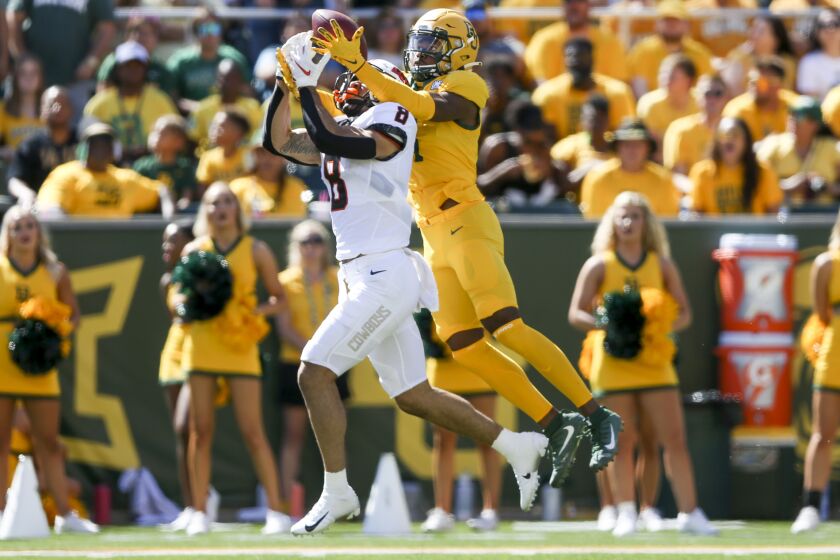 Baylor cornerback Lorando Johnson (11) breaks up a pass intended for Oklahoma State wide receiver Braydon Johnson (8) during a NCAA football game between Oklahoma State and Baylor in Waco, Texas on Saturday, Oct. 1, 2022. (Ian Maule/Tulsa World via AP)