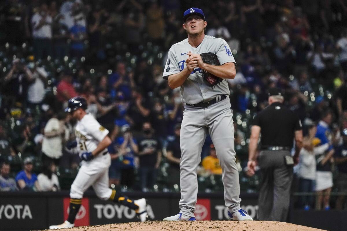 Dodgers reliever Garrett Cleavinger reacts after giving up a home run to Milwaukee's Travis Shaw.