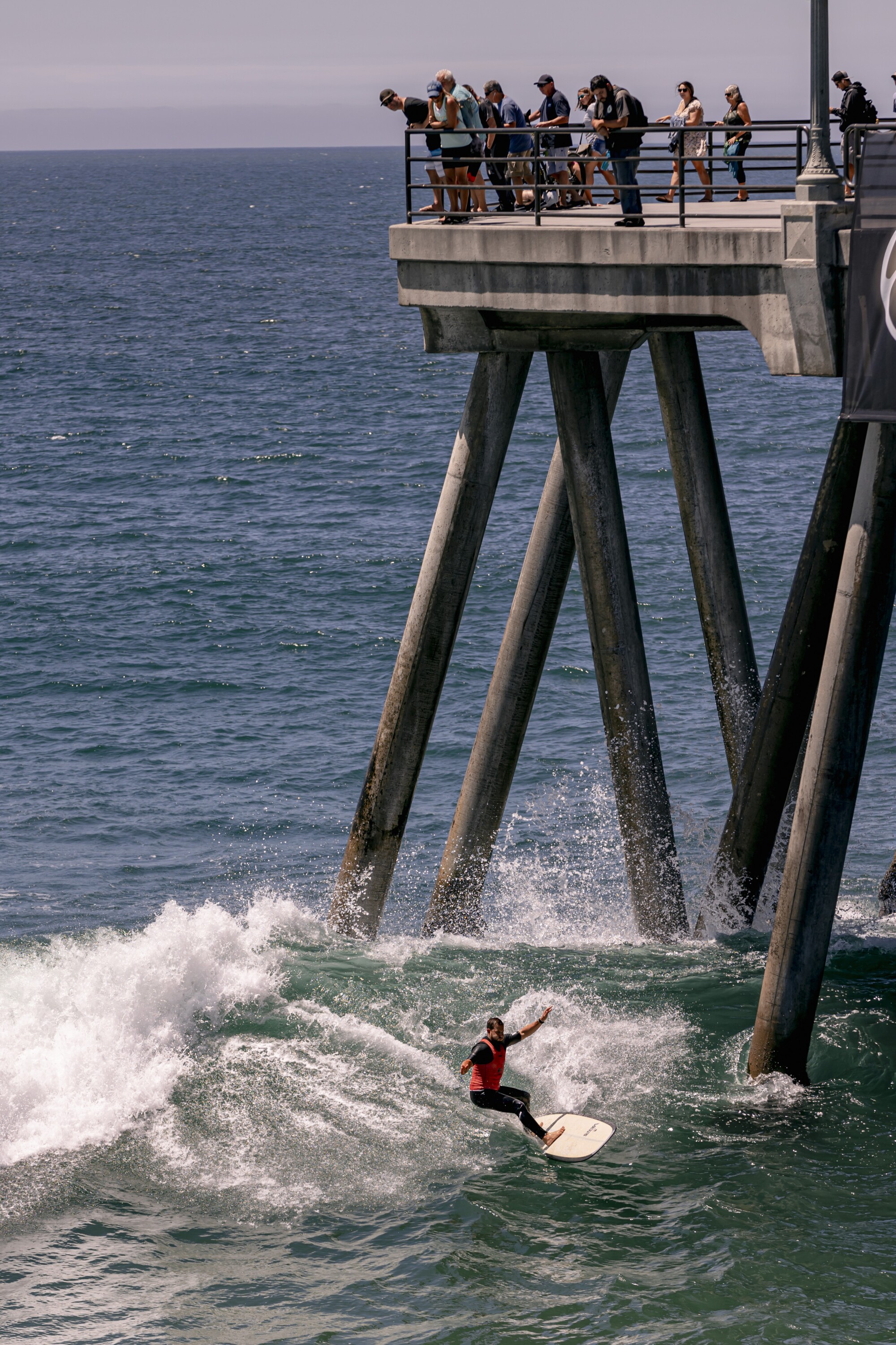 Harrison Roach competes in the longboard competition near the Huntington Beach pier at the U.S. Open of Surfing.