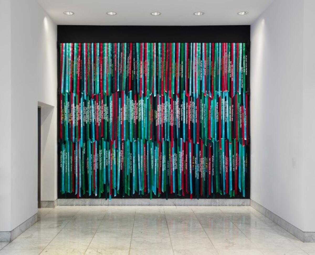An image of silk-screened colorful ribbons on a wall.