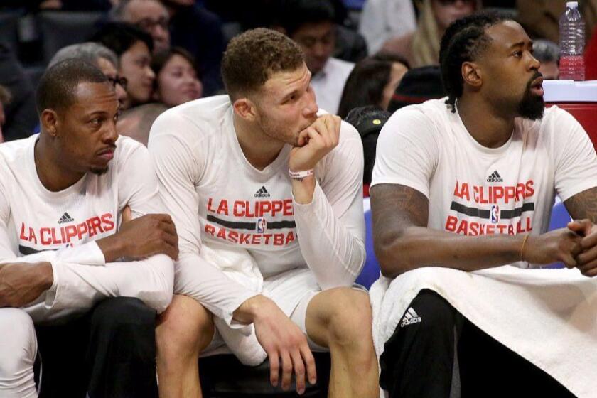 Clippers Paul Pierce, Blake Griffin and DeAndre Jordan (left to right) look on from the bench during a game against the Warriors on Dec. 7.