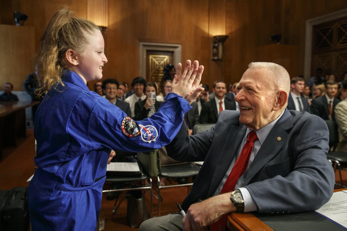 Amelia Gillespie, 9, of Arnold, Md., greets Apollo 11 mission director Eugene Kranz before a congessional hearing in Washington this year.