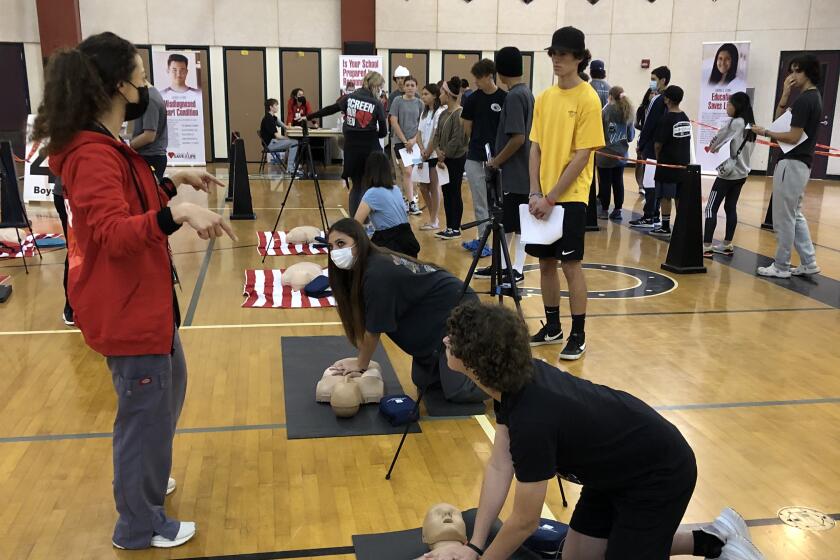 Madison Middle School students practice CPR (cardiopulmonary resuscitation) at a free heart screening.