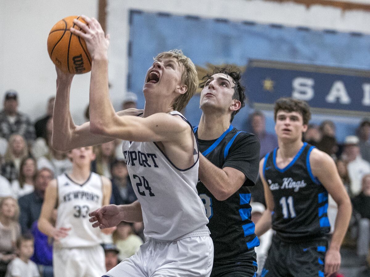 Newport Harbor's Adam Gaa goes up for a shot against Corona del Mar's Derek Curry during Wednesday's game.