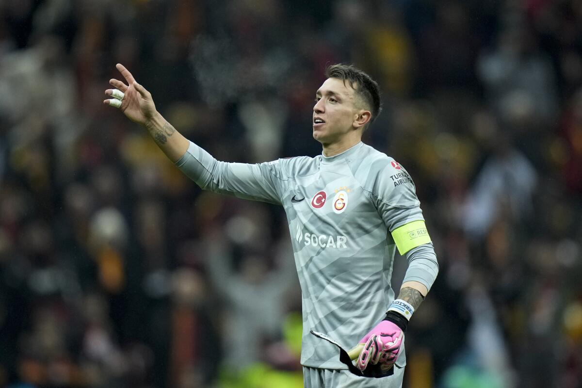 FILE - Galatasaray's goalkeeper Fernando Muslera celebrates with supporters at the end of the Europa League play-off first league soccer match against Sparta Praha, in Istanbul, Turkey, Feb. 15, 2024. Muslera, who played in the past four World Cups, announced his retirement from international soccer on Thursday, April 25, 2024. (AP Photo/Francisco Seco)