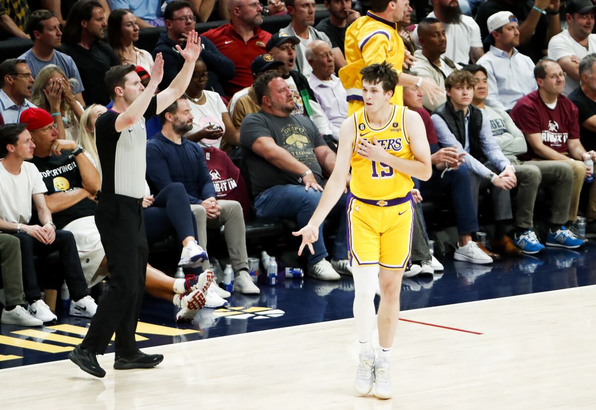 Lakers guard Austin Reaves reacts with the "ice in veins" pose after making a three-point basket late in Game 1.