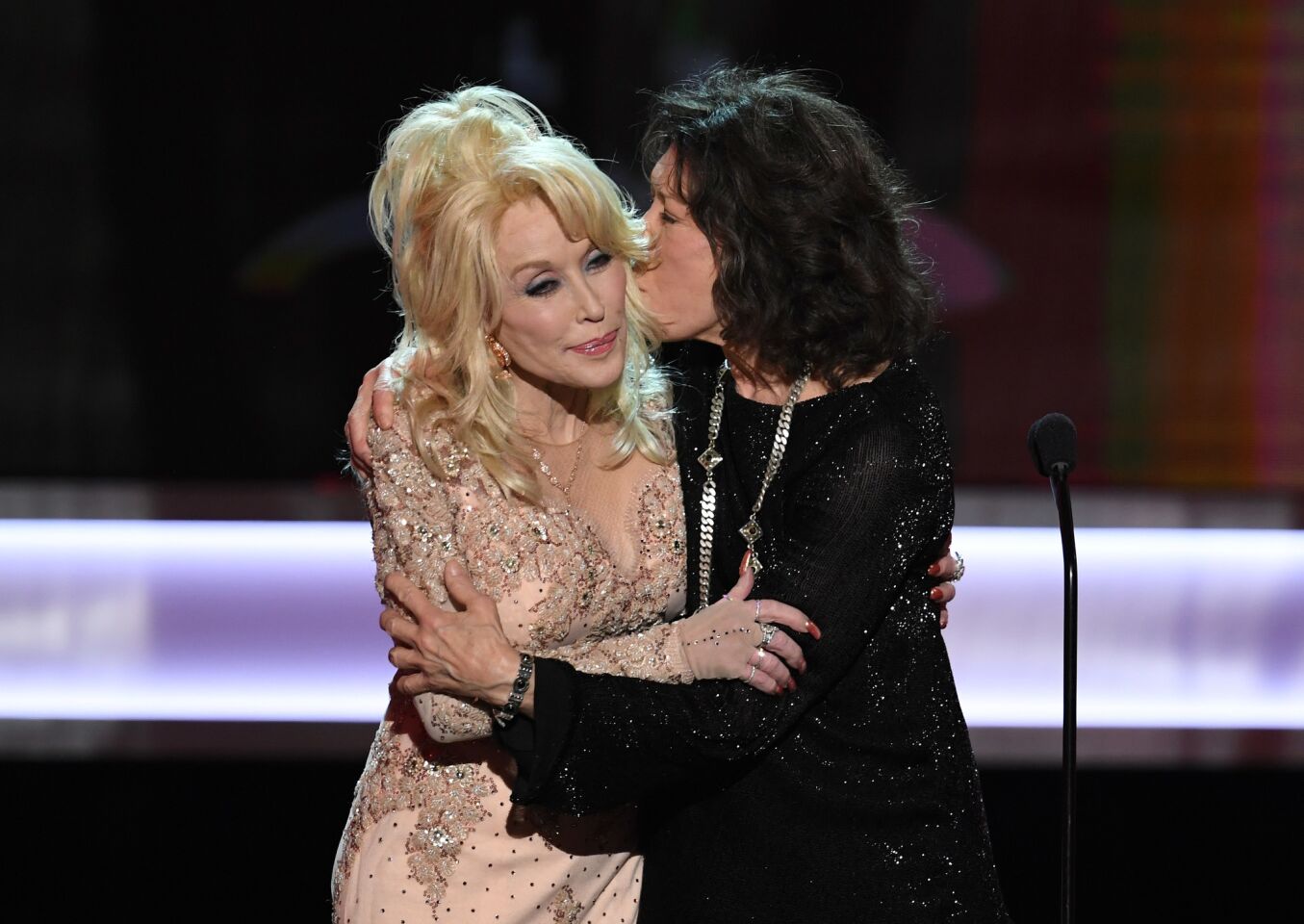 Lily Tomlin, right, accepts the life achievement award from Dolly Parton.