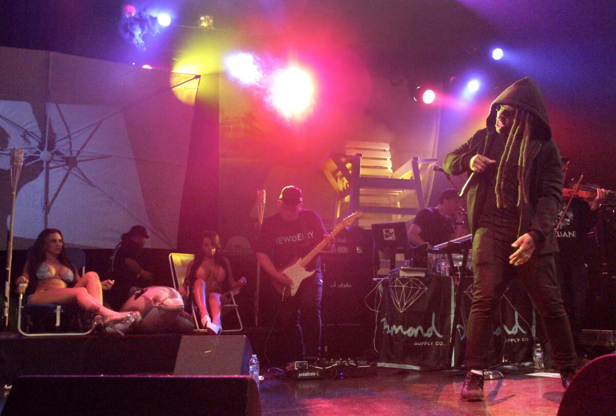 Compton R&B artist Ty Dolla Sign, right, performing with a multi-piece band and a couple of bikini clad ladies at the El Rey Theatre.