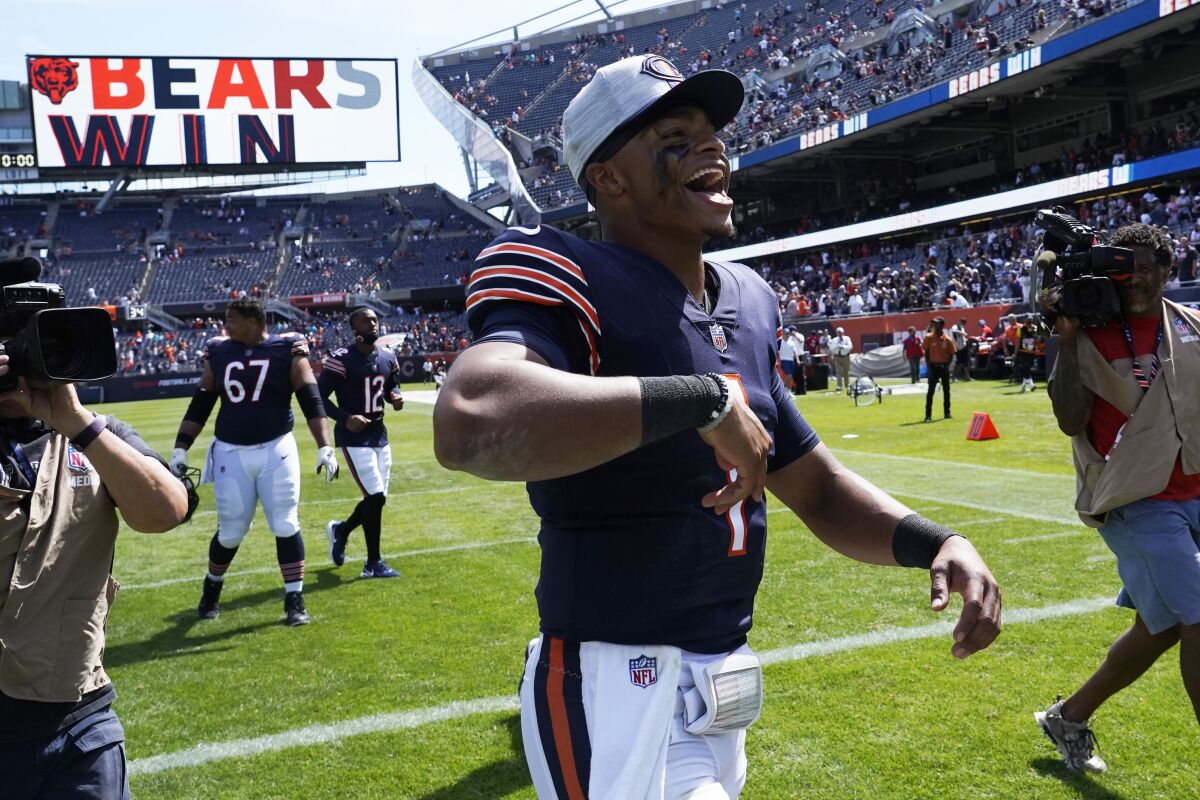 Chicago Bears quarterback Justin Fields (1) celebrates a victory over the Miami Dolphins in an NFL preseason football game in Chicago, Saturday, Aug. 14, 2021. (AP Photo/David Banks)
