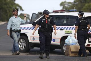 Police work near the scene of a fatal shooting in Wieambilla, Australia, Tuesday, Dec. 13, 2022. Multiple people, including a few police officers, were shot and killed at a property in rural Australia after officers who arrived to investigate reports of a missing person were ambushed, authorities said. (Jason O'Brien/AAP Image via AP)