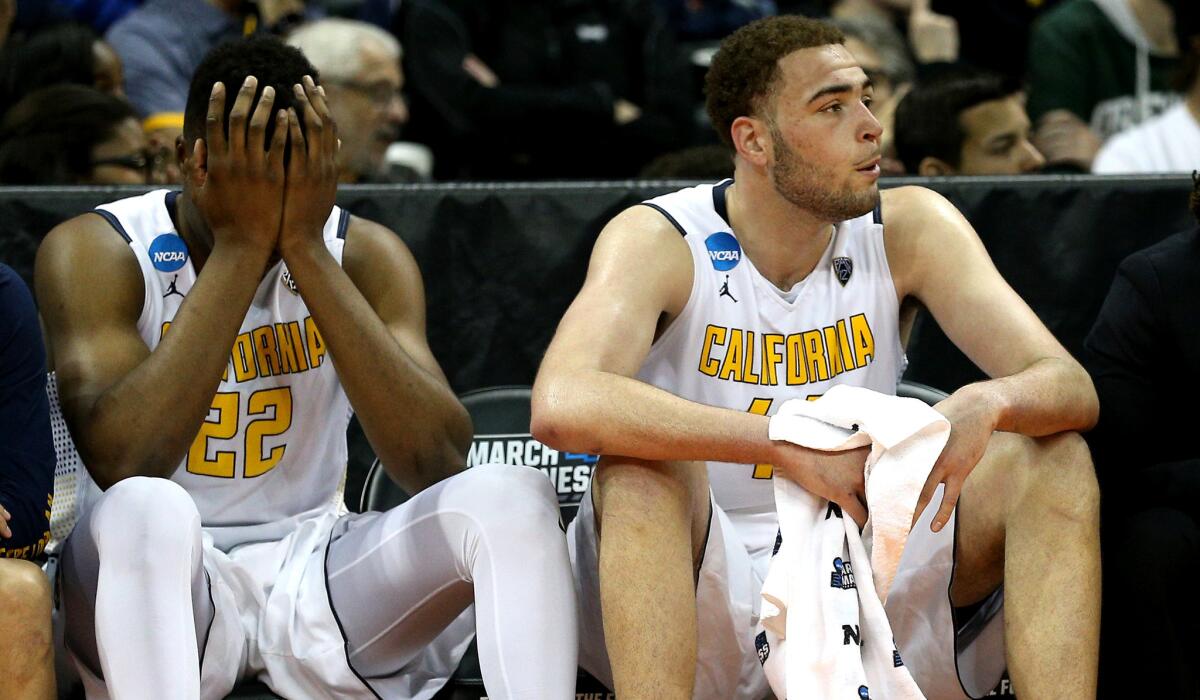 California's Kingsley Okoroh (22) and Kameron Rooks can barely stand to watch the closing moments of a loss to Hawaii on Friday.