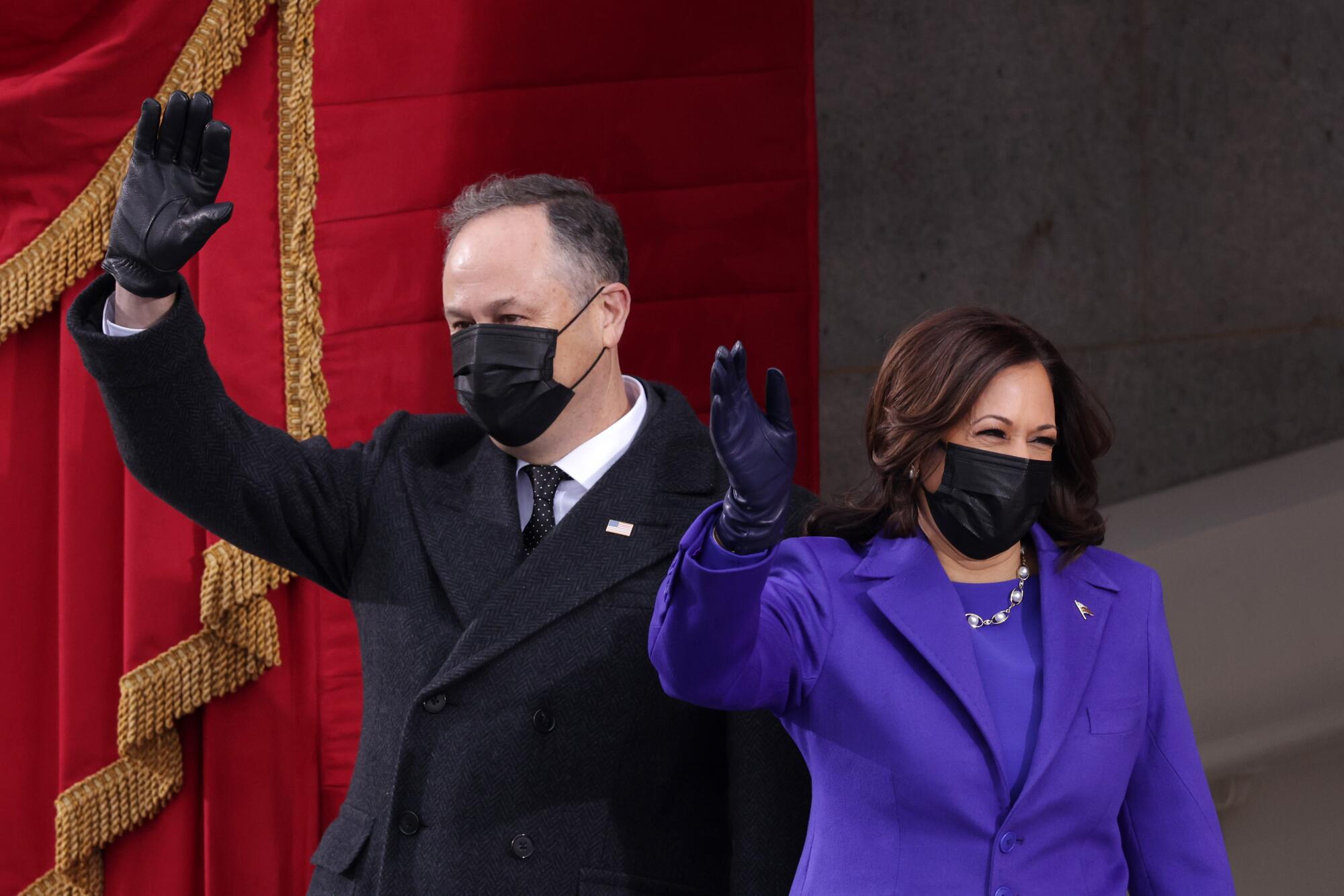 Vice President-elect Kamala Harris and husband Doug Emhoff wave at the inauguration.