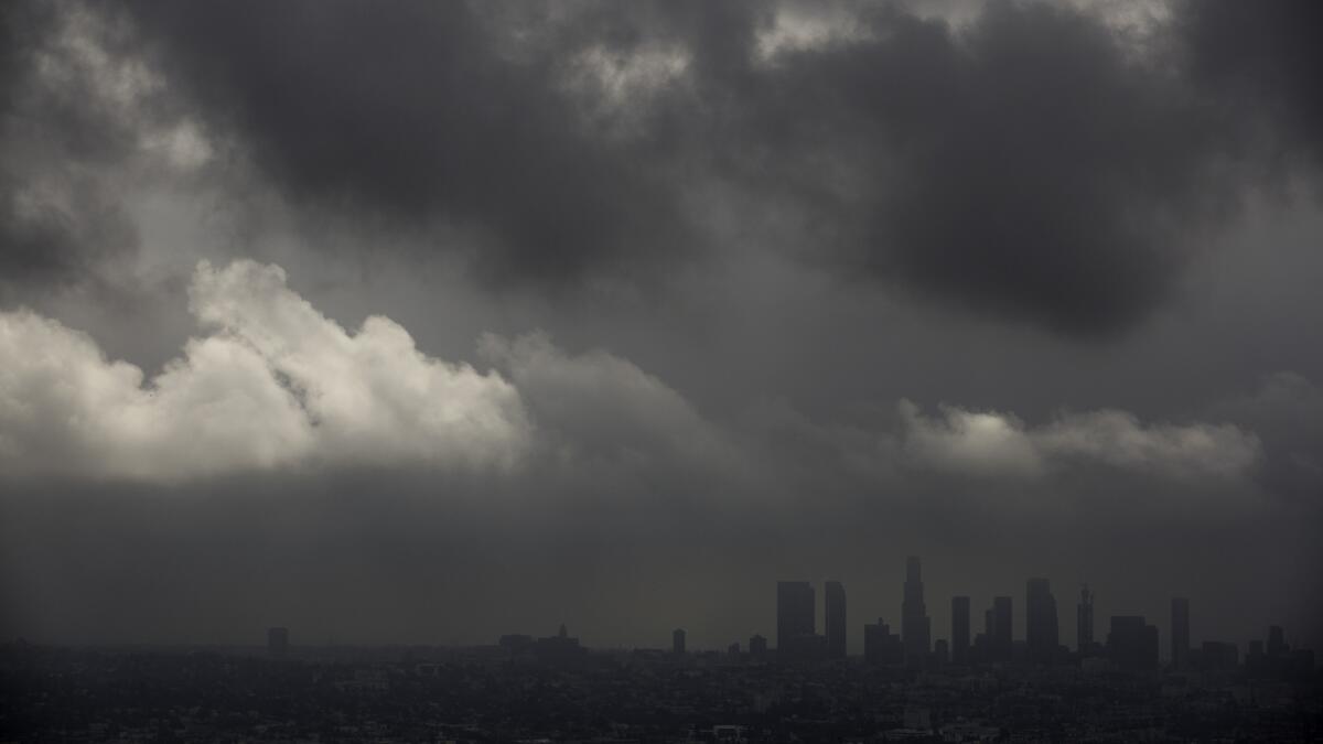 Low clouds drift over the Los Angeles Basin and downtown in Los Angeles on Oct. 18. Cooler temperatures are moving back into Southern California this week.