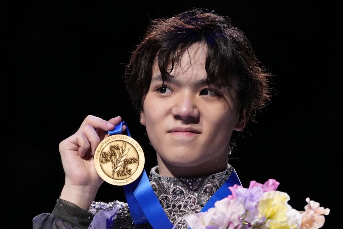 Shoma Uno of Japan shows off his gold medal after winning the men's free skating in the World Figure Skating Championships in Saitama, north of Tokyo, Saturday, March 25, 2023. (AP Photo/Hiro Komae)