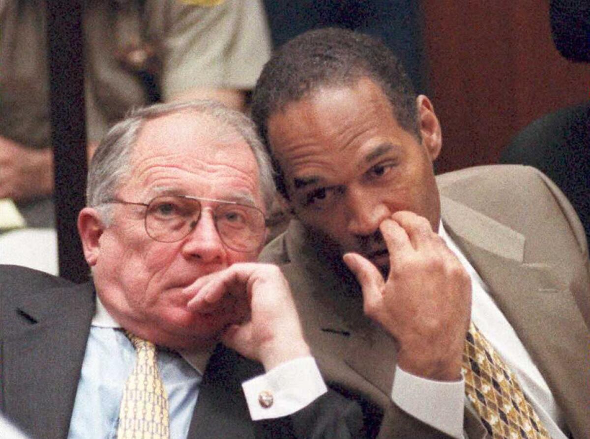 O.J. Simpson whispers to Defense attorney F. Lee Bailey